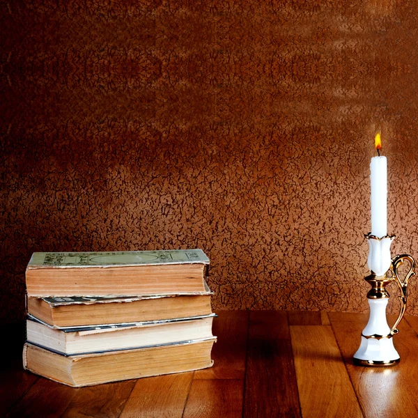 Old stack of books with candlestick — Stock Photo, Image