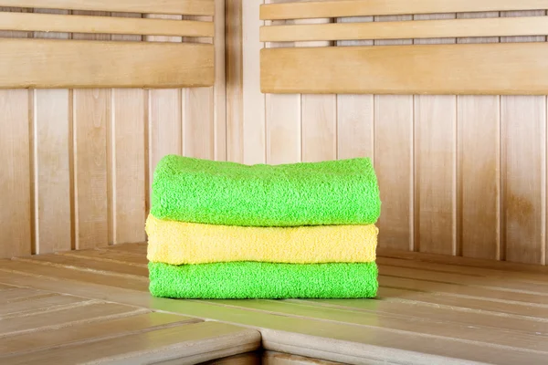 Traditional wooden sauna for relaxation with set of clean towels — Stock Photo, Image