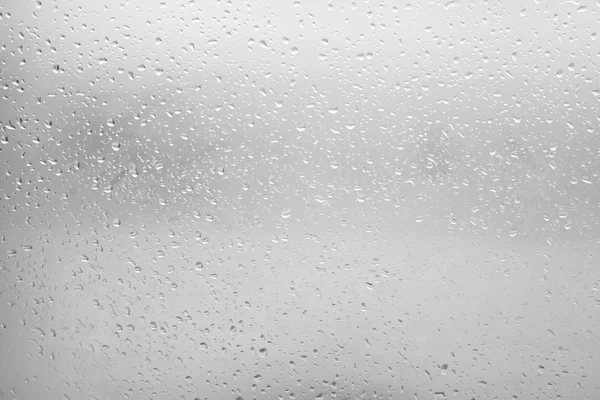 Flowing water drops on the glass in a gloomy autumn day — Stock Image Flowing water drops on the glass in a gloomy autumn day Stock Photo