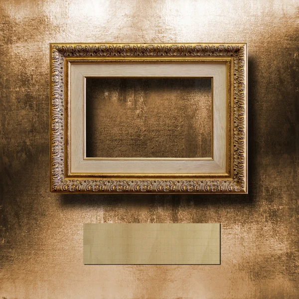 Old gilded picture frame for  portrait on  shabby cement wall — Stock Photo, Image