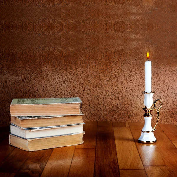 Old stack of books with candlestick — Stock Photo, Image