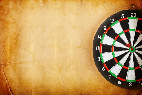 Vintage dart board on dark wall grunge — Stock Photo, Image