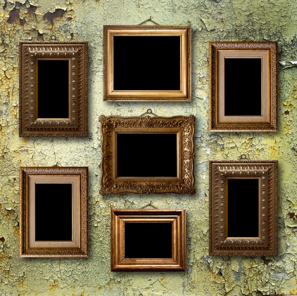 Gilded wooden frames for pictures on old  rusty metallic wall — Stock Photo, Image