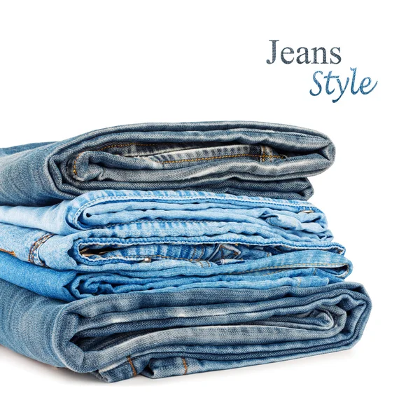 Pila di pantaloni jeans isolata su sfondo bianco — Foto Stock