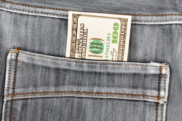 A hundred dollar bills sticking in the back pocket of denim blac — Stock Photo, Image