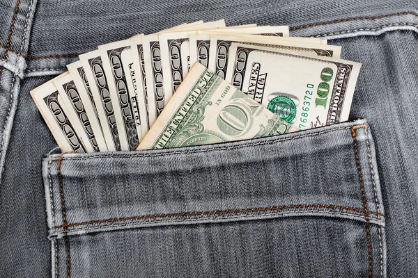A hundred dollar bills sticking in the back pocket of denim blac — Stock Photo, Image