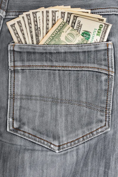 A hundred dollar bills sticking in the back pocket of denim blac — Stock Photo, Image