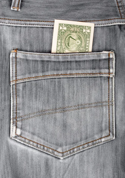 Un billet d'un dollar collant dans la poche arrière de jean noir denim — Photo