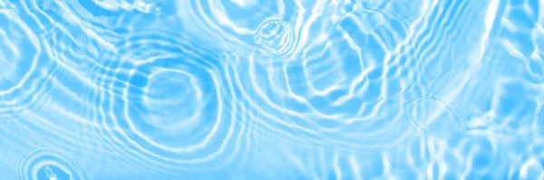 Water panoramic banner background. Water texture, water surface with rings and ripple. Spa concept background. Flat lay, top view, copy space, composition with copy-space.
