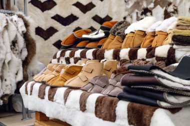 Natural fur skins. Handmade shoes. Street sale of fur products.