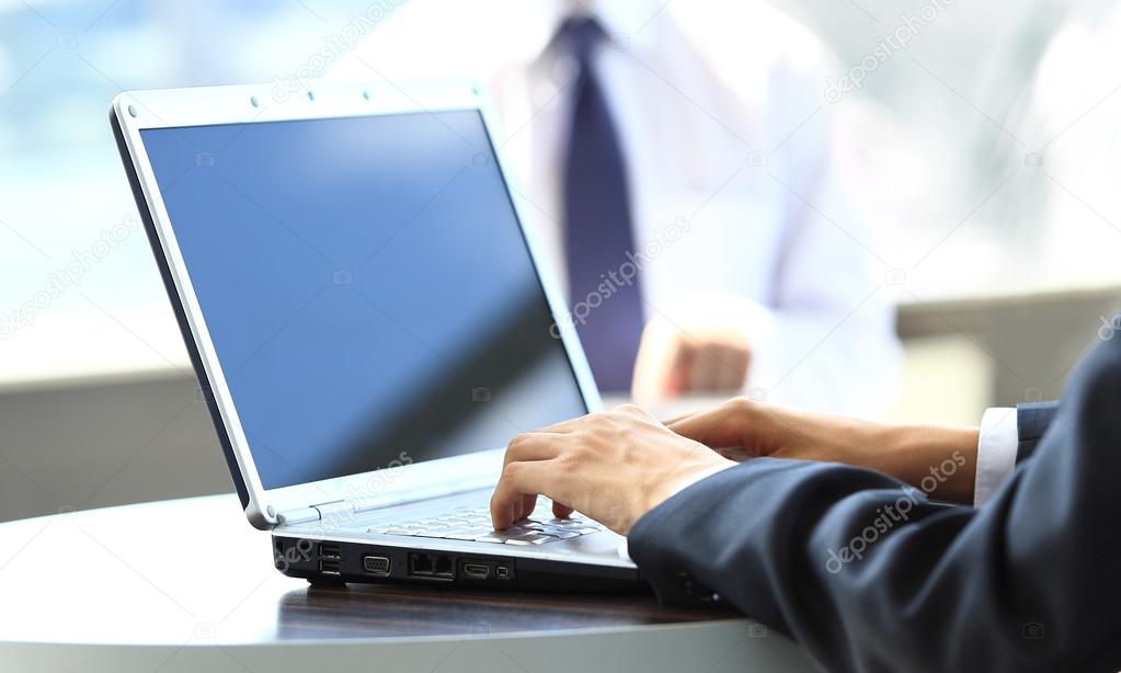 Person Typing on a modern laptop in an office