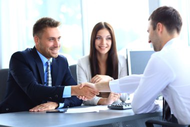 Businessman shaking hands to seal a deal with his partne