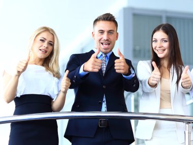 Business team with the thumbs up in a stairs
