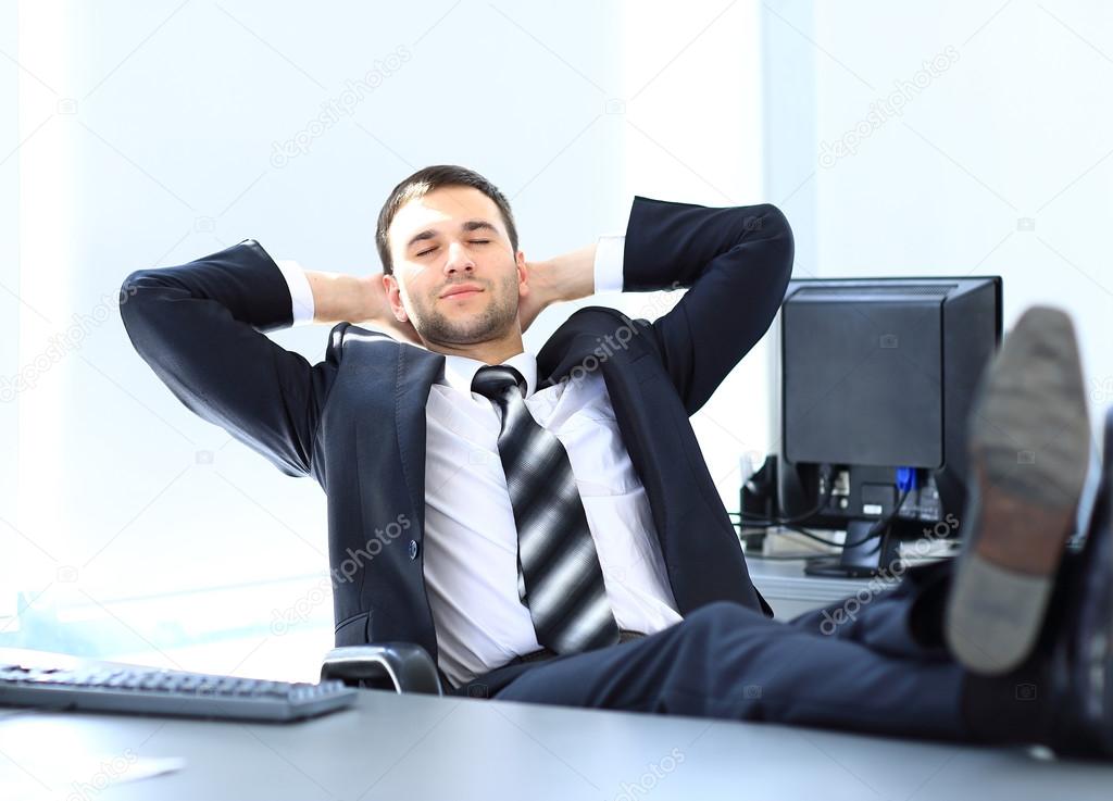 Satisfied businessman relaxing in his office