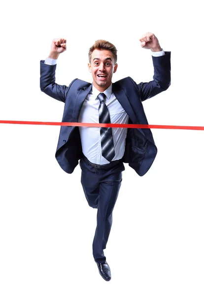 Feliz hombre de negocios corriendo a través de la línea de meta. Aislado sobre blanco — Foto de Stock