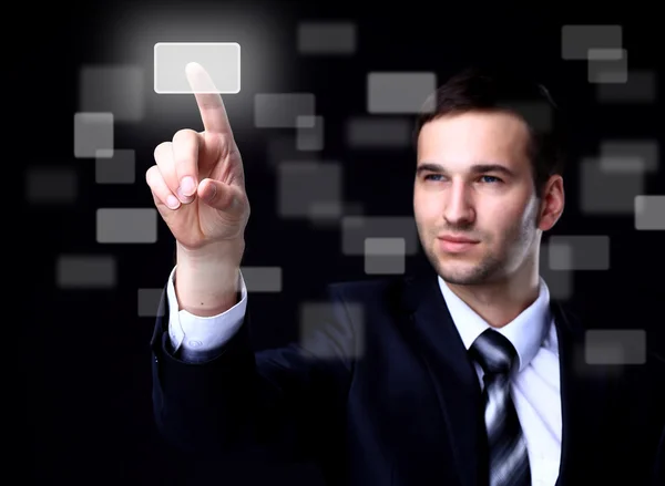 Business man pressing a touchscreen button on dark background Stock Image