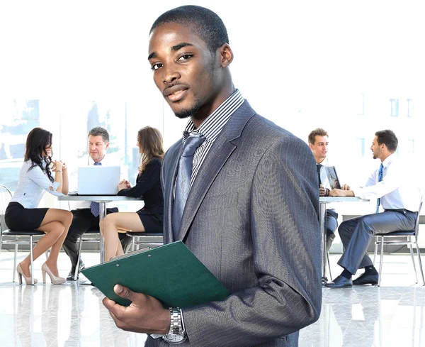 African american businessman in modern office with colleagues on background Stock Image