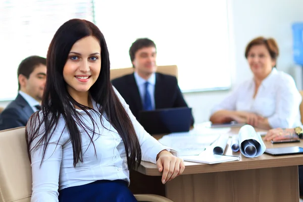 Young businesswoman and her colleagues — Stock Photo, Image