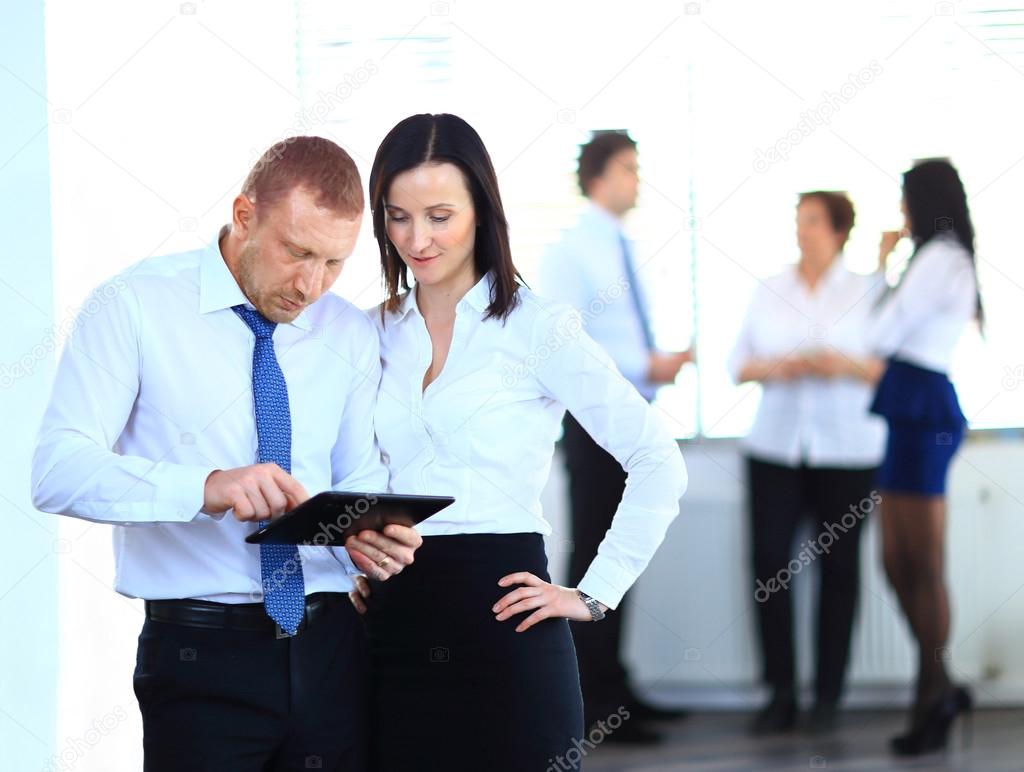 Group of business people using tablet computer in office