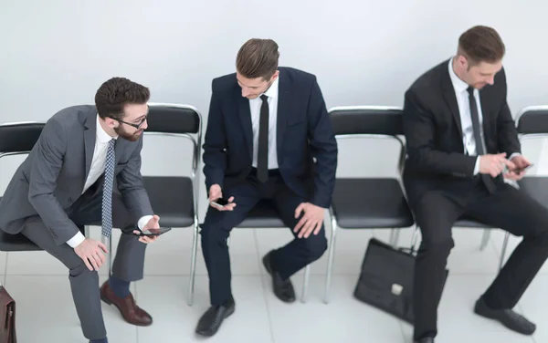 Mitarbeiter kommunizieren, sitzen im Büroflur. — Stockfoto