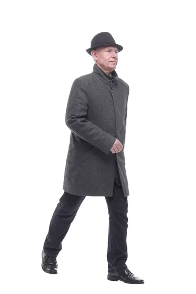 Intelligent man in an autumn coat striding forward. — Stock Photo, Image