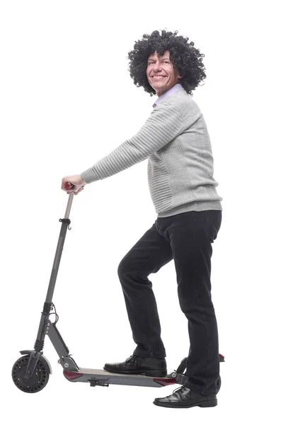 In full growth. cheerful man with an electric scooter. — Stock Photo, Image