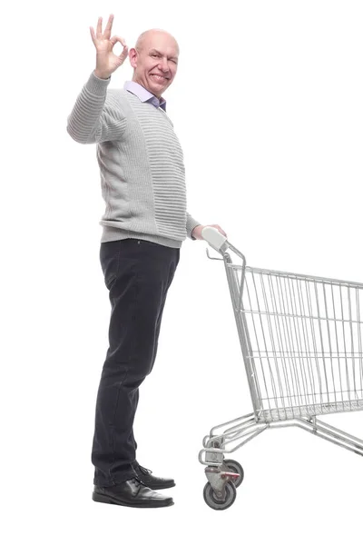In full growth. a happy man with a shopping cart. — Stock Photo, Image