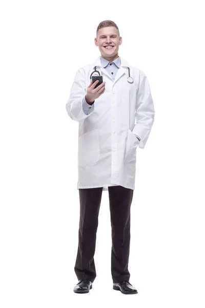 In full growth. young doctor with a smartphone. — Stockfoto
