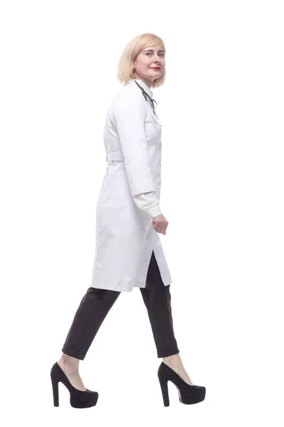 자격있는 여성 의사 가 앞으로 걸어 옵니다. 하얀 배경에 고립되어 있다. — 스톡 사진