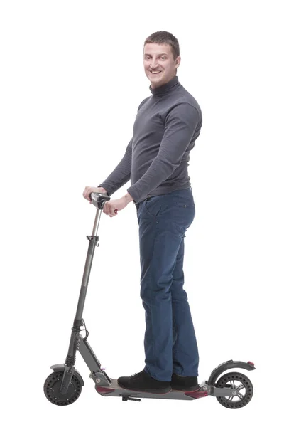 In full growth. casual young man with an electric scooter. — Stockfoto