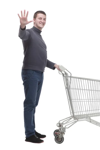 In full growth. casual young man with shopping cart. — Fotografia de Stock