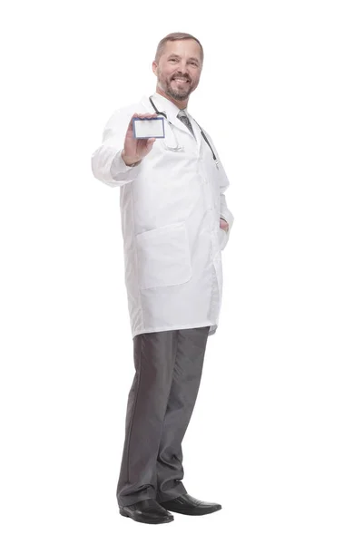 In full growth. smiling doctor showing his visiting card . — Stock Photo, Image