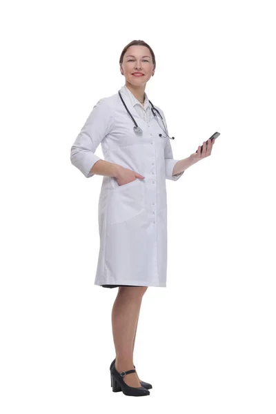 In full growth.female doctor with a smartphone. — 图库照片