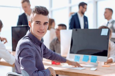 Kapat. genç profesyonel ofis masasında oturuyor.