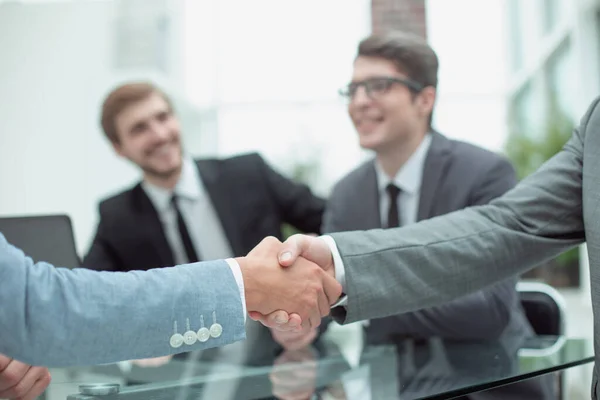 Handslag av affärsmän på suddig kontorsbakgrund. — Stockfoto