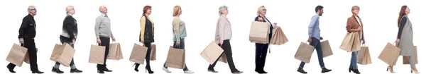 A group of people are running paper shopping bags — Stock Photo, Image