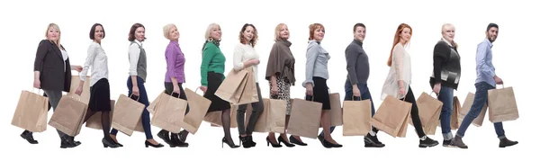 A line of people with shopping bags. side view — Stockfoto