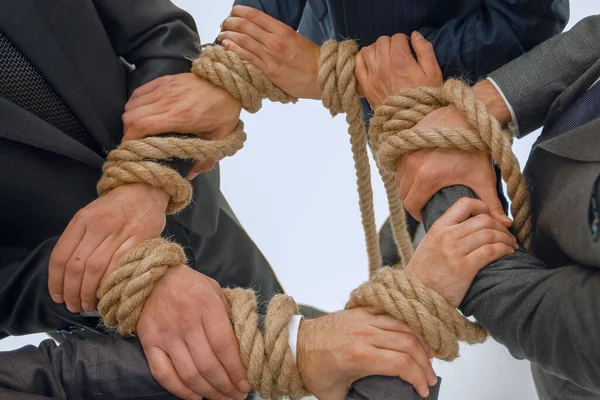 Closeup.unified business team, tied a strong rope . — стоковое фото