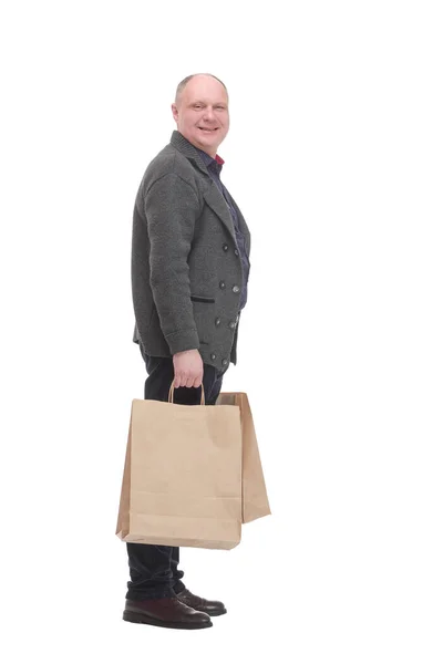 쇼핑 가방을 들고 있는 쾌활 한 남자, 하얀 배경에 고립되어 있다. — 스톡 사진