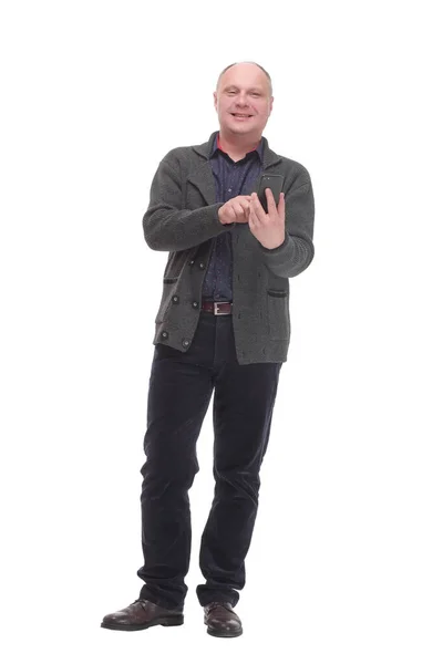 Smiling mature man with a smartphone .isolated on a white background. — Zdjęcie stockowe