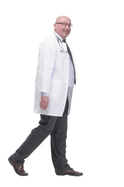 Confident mature doctor in a white coat striding forward . — 图库照片