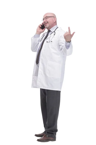 Mature doctor with smartphone. isolated on a white background. — стоковое фото