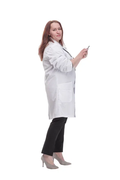In full growth. qualified female doctor with a smartphone. — Fotografia de Stock