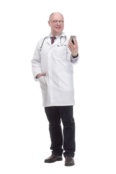 Modern mature doctor with smartphone. isolated on a white background. — Stockfoto