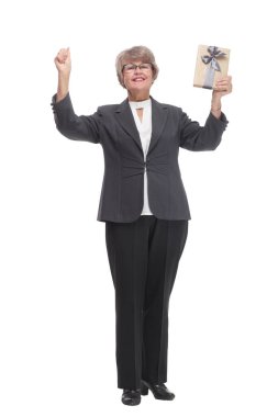 Middle age woman holding a gift standing over isolated white background very happy with hands up
