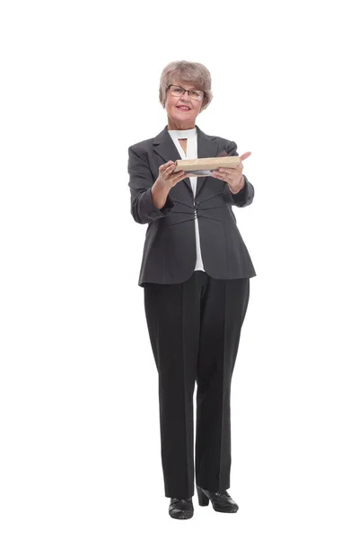 Full body senior woman happy and smiling, holding a gift and pointed on it — 스톡 사진