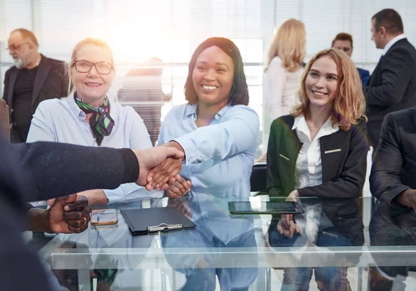 Glimlachende zakenvrouw schudden handen met haar zakenpartner. — Stockfoto