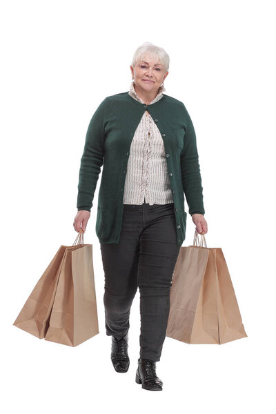 Full body senior woman cheerful and smiling, very excited carrying a shopping bags