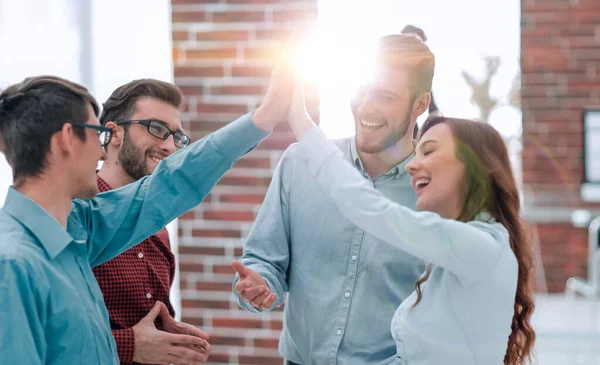 Happy creative business people giving high-five in meeting room. — Stock Photo, Image