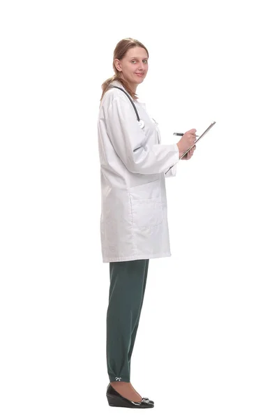 Side view of female doctor filling up medical form on clipboard — Stock Photo, Image